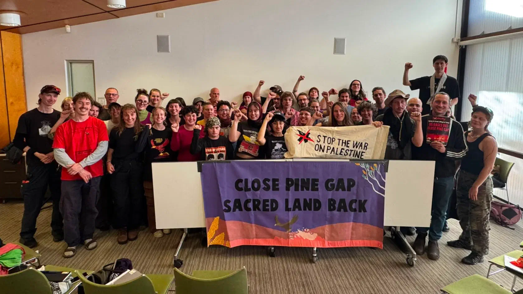 SWOP, Solidarity, and other activists gather after a session at the Pine Gap convergence.