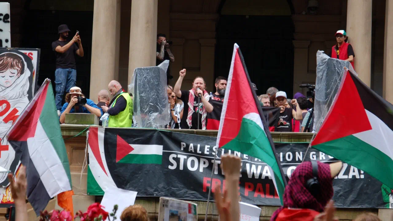 Palestine Action Group organiser Josh Lees addresses protestors outside Sydney Town Hall.