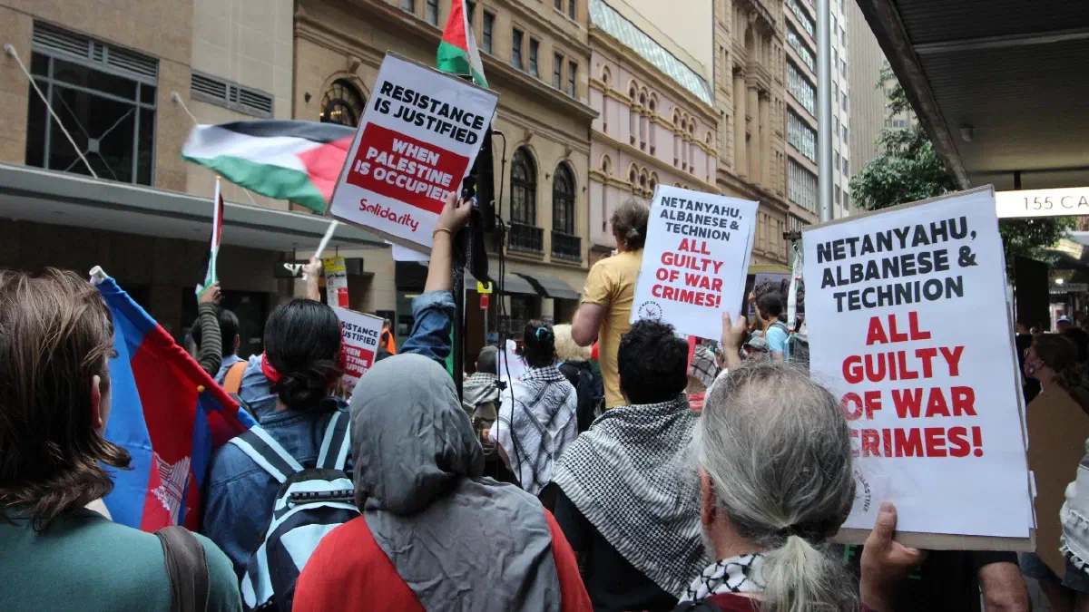 Protestors hold up placards across the road from Technion’s 100-year dinner event at the Great Synagogue, Sydney.