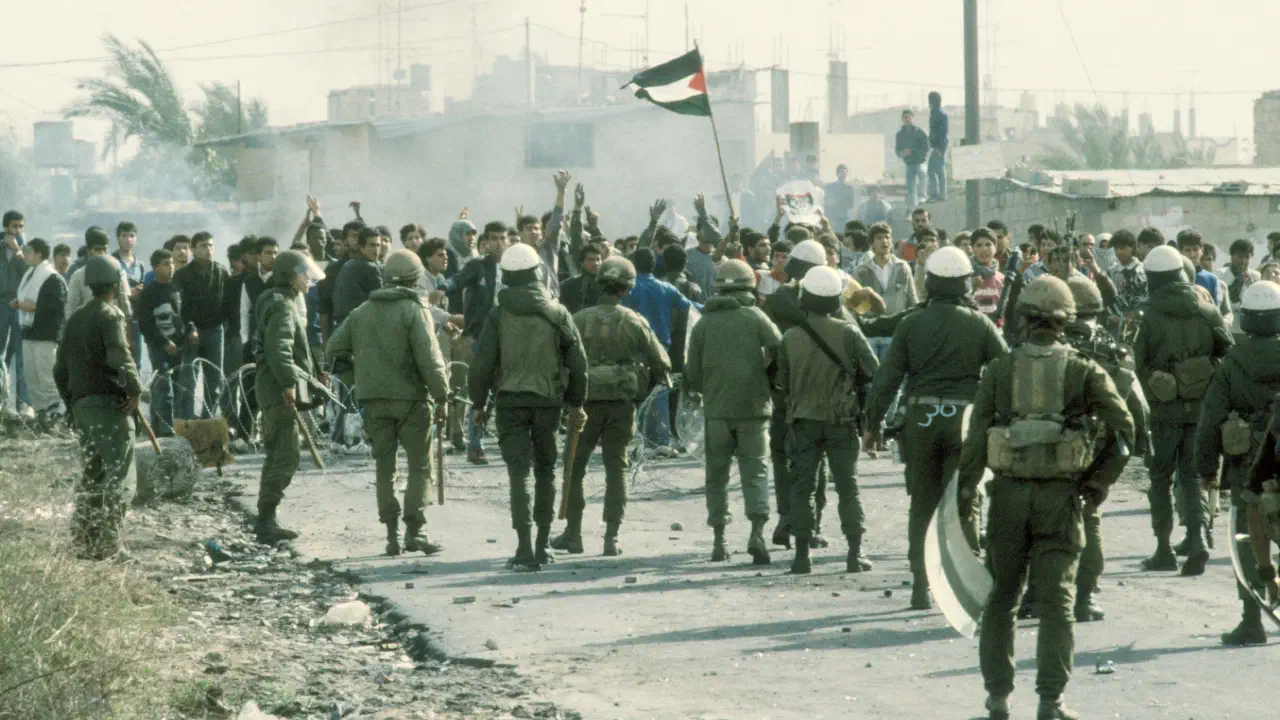Razor wire runs between Palestinian protestors and Israeli troops.