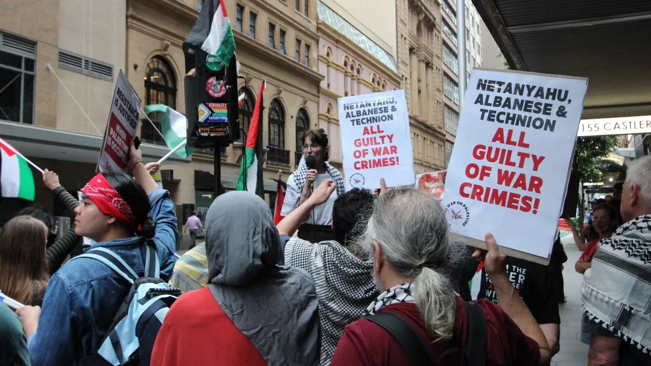 Protestors hold up placards outside the Technion event in Sydney.