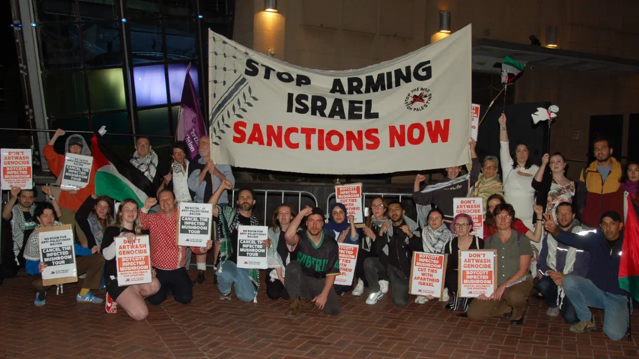 Protestors gather in Darling Harbour to call on Home the Venue to cancel Infected Mushroomʼs show.
