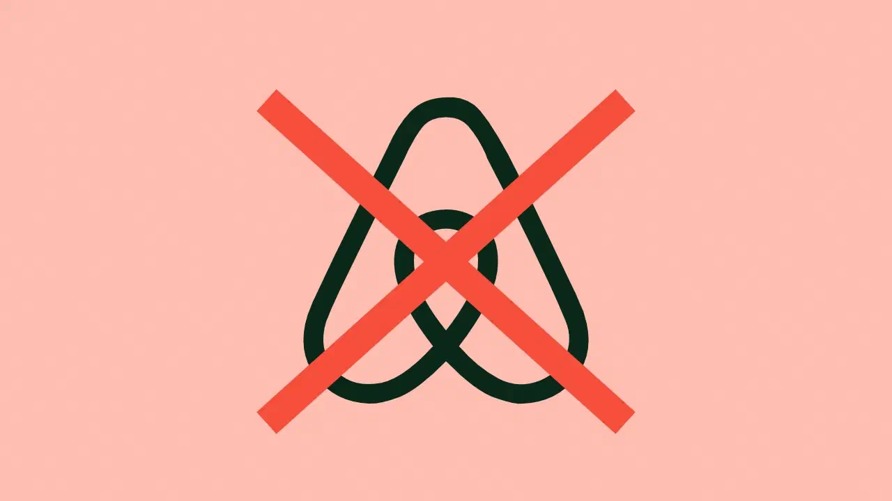 The Airbnb logo covered with a red cross.