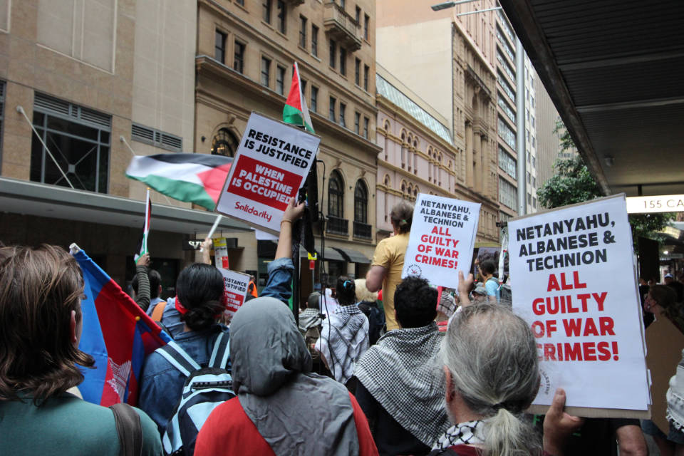 Protestors hold up placards across the road from Technion’s 100-year dinner event at the Great Synagogue, Sydney