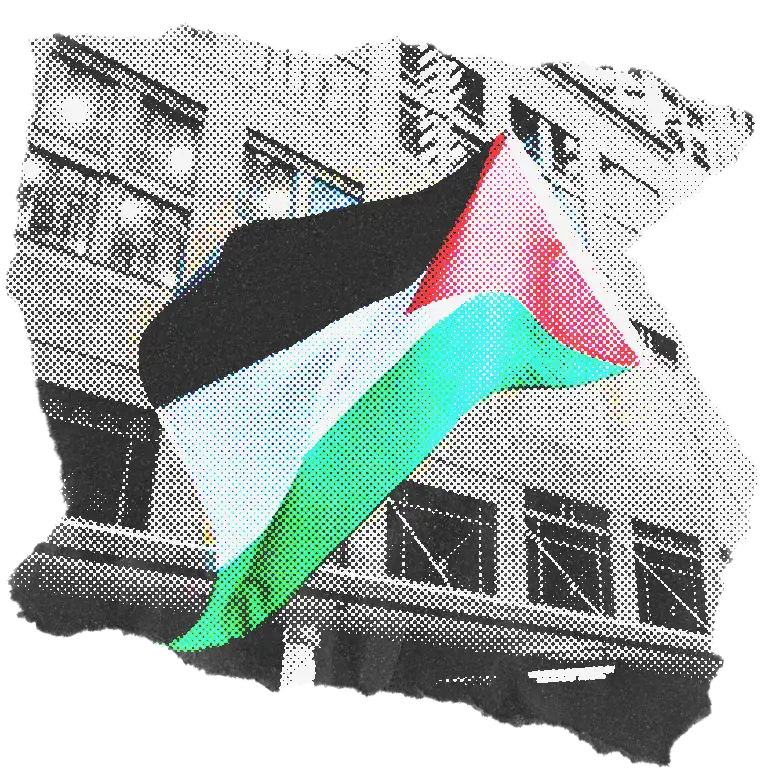 A Palestinian flag waving in front of city buildings